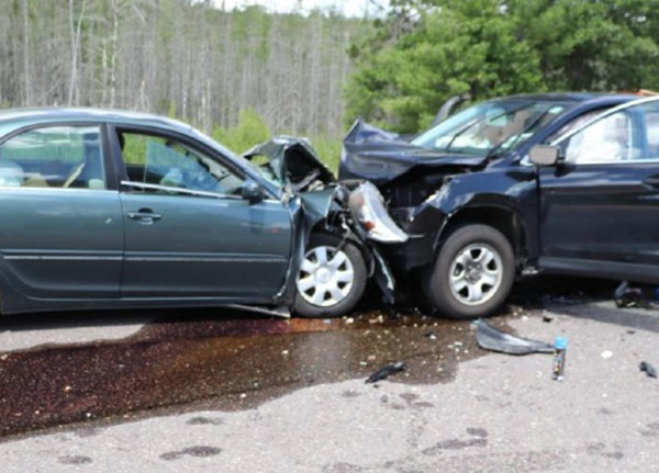 Two vehicles involved in a head-on collision at an intersection, illustrating accident reconstruction analysis.