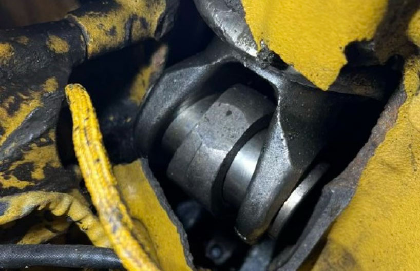 Close-up view of an industrial mechanical component showing internal wear and gear teeth, used for failure analysis and forensic component evaluation.