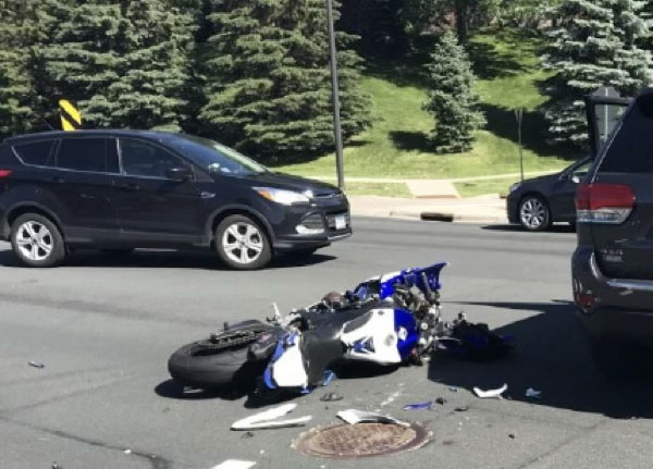 Motorcycle and vehicle involved in a collision at an intersection, documented for forensic photogrammetry and accident reconstruction.