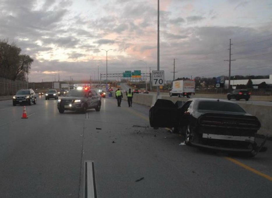 A forensic analysis scene showing a collision between a sedan and a motorcycle at an intersection, documented for mechanical failure and accident investigation